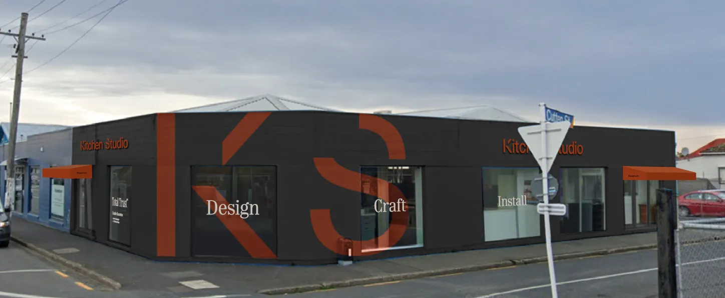 Kitchen Studio corner showroom with large rust-coloured KS lettering and Design, Craft and Install window signs